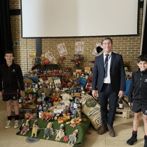 students and teacher at a harvest festival