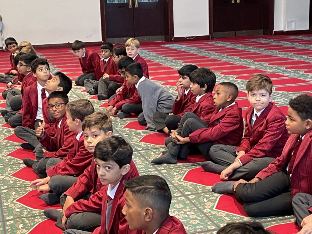 students sitting in a masjid