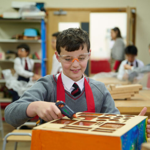 student using a glue gun