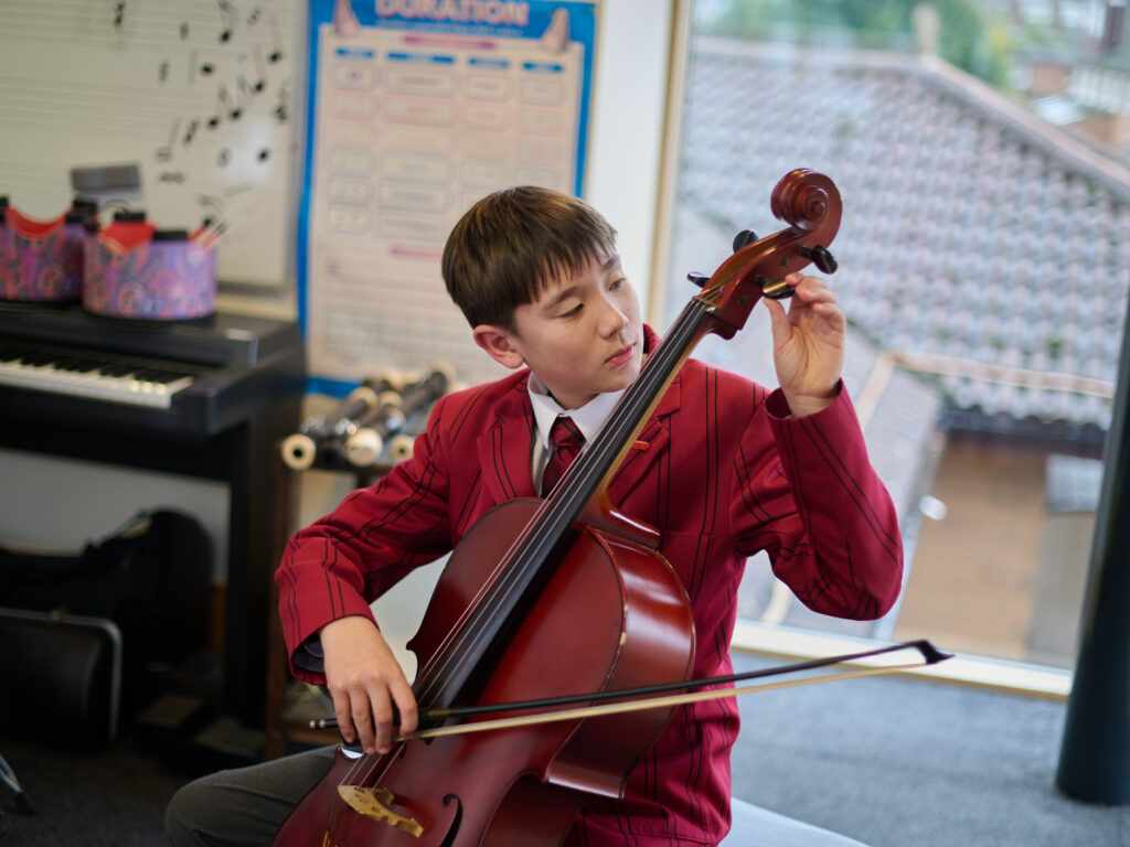 student using a cello