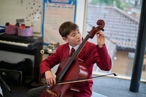 student using a cello